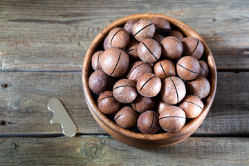 Macadamia nuts on wooden background