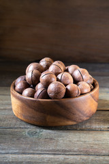 Macadamia nuts on wooden background