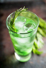 Sweet tequila based green cocktail with tarragon and rosemary. Selective focus. Shallow depth of field.