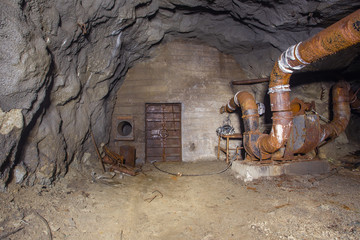 Underground abandoned iron ore mine tunnel with massive door