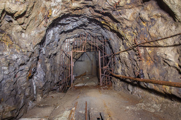 Underground old abandoned iron mine tunnel with doors gates