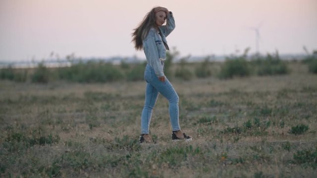 girl in jeans clothes walking in nature