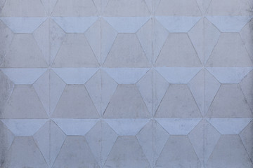 The gray background of concrete fence wall with square and triangle pattern