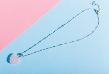 Women's Jewelry. Trendy jewelry on coloured background. Flat lay, top view.