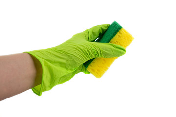 Sponge for dishes in a female hand in a green glove isolated on a white background. Copy space.