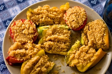 Peppers and tomatoes cooked 'au gratin' in a white dish (Pesaro, Italy, Europe)