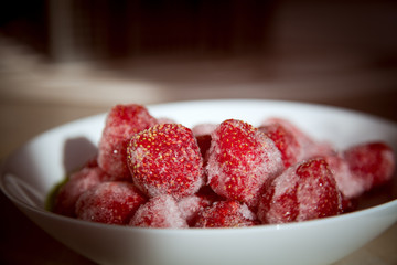 A full plate of strawberries covered in frost