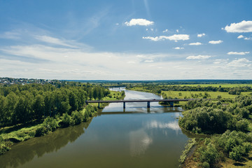 Naklejka na ściany i meble A road bridge near the city of Alatyr, Chuvash Republic, Russia. The rural landscape of the Alatyr River.
