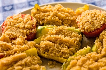 Peppers and tomatoes cooked 'au gratin' in a white dish (Pesaro, Italy, Europe)