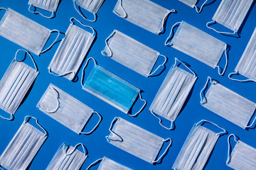 Medical masks on blue background. Face mask protection, virus, flu, coronavirus, COVID-19