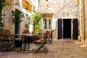 Naklejka na ściany i meble Street cafe on a narrow street in the old town of Kotor, Montenegro