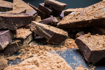 Big chopped chocolate with cocoa, big pieces. Dessert, sugar, carbohydrates and fats concept.
