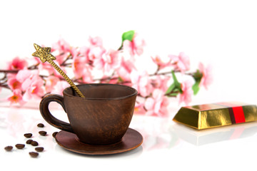 coffee cup with a spoon against the background of cherry blossoms