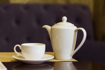 Tea cup and tea pot on table. Breakfast and Five O'Clock Tea. Tea time.