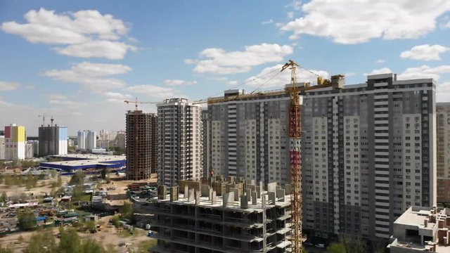 Aerial view of building construction site with crane and workers