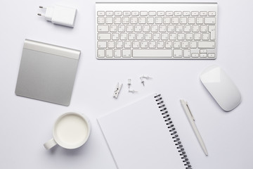 Empty white notebook with pen, working place with keyboard.