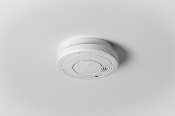 Smoke detector on the white ceiling. Stay home safe. Home control and security.  Smoke detector