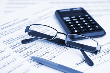 Naklejka na ściany i meble Bankruptcy concept. Close-up pen, calculator and glasses at financial report.