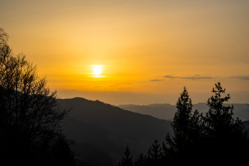 Germany, Romantic orange black forest nature landscape sunset sky view at sunset from above with silhouette like mountains