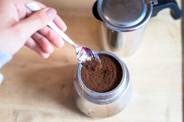Preparing fresh coffee with a vintage steal coffee cooker