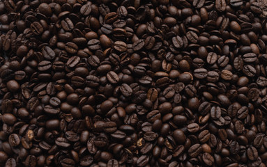 Coffee beans lying on background