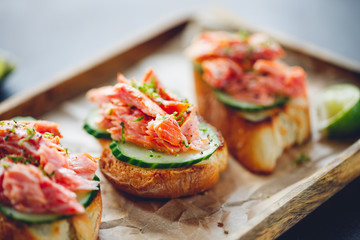 Toasts with fresh cucumber and smoked salmon