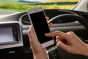 Women holding cellphone in the car