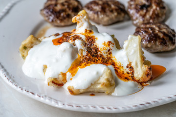 Healthy Organic Vegetarian Cauliflower with Yogurt, Fried Butter Sauce and Turkish Style Meatballs Kofte or Kofta / Yoghurt.