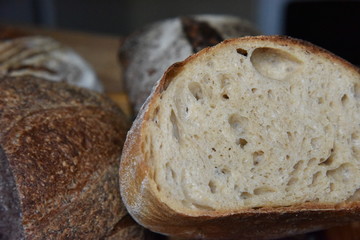 A fresh crusty loaf of homemade bread. Homemade rustic sour. Brown bread. Different types of loaves. Sliced Bread