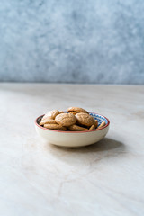 Chewy Soft Italian Amaretti Cookie Biscuits in Ceramic Bowl.