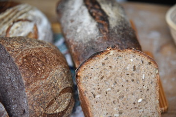 A fresh crusty loaf of homemade bread. Homemade rustic sour. Brown bread. Different types of loaves. Sliced Bread