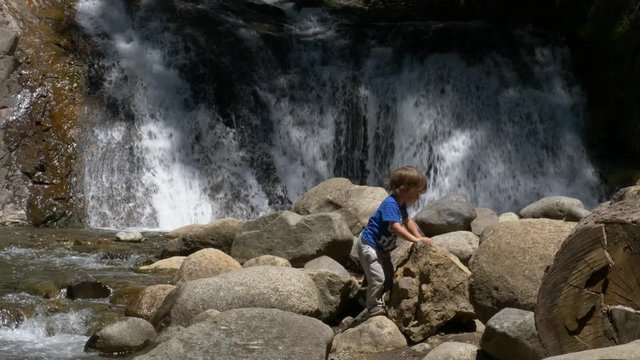 Little boy Playing on a Waterfall in Patagonia