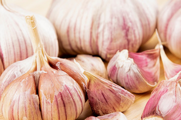 Garlic bulbs and cloves on a wooden cutting board
