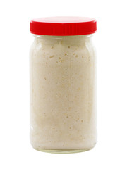 Jar of horseradish sauce isolated on white