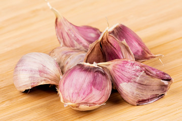 Garlic cloves on a wooden cutting board