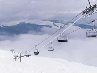 A cablaway with chairlift in a winter day