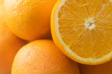 A slice of orange on a background of oranges