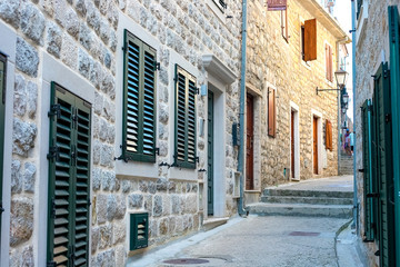 Winding street of the authentic, old town of Herceg Novi, Montenegro. We see old houses and very narrow