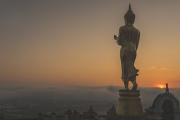 Wat Phrathat Khao Noi with Sunrise and the mist. This temple is the best location view of Nan province, Thailand.