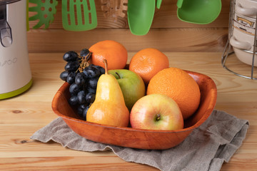 Fresh fruits on a wooden background, cutting wooden board and knife