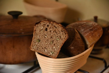 A fresh crusty loaf of homemade bread. Homemade rustic sour.
Brown bread. Different types of loaves. Sliced Bread. Atmosphere image of a countryside style kitchen.