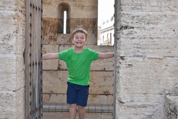 Happy little boy on an excursion in an old castle