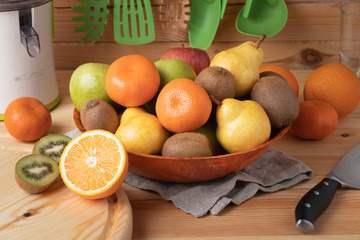 Fresh fruits on a wooden background, cutting wooden board and knife