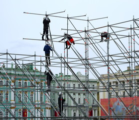 Assembly of the metal frame by high-rise workers