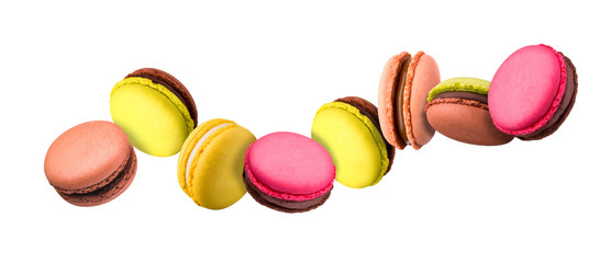 Set of flying french colorful macaroons isolated on white background