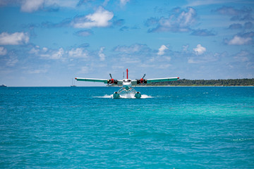 Sea plane at tropical beach resort. Luxury summer travel destination with seaplane in Maldives islands. Exotic vacation or holiday transportation, Maldives sea