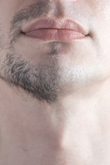 Obraz premium A close-up of a man's half-shaven chin. Man shaving concept.