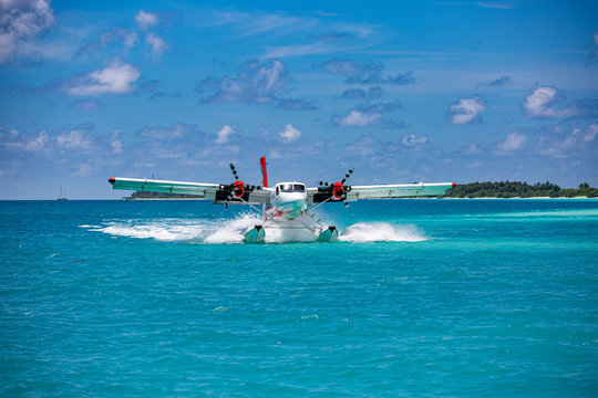 Sea plane at tropical beach resort. Luxury summer travel destination with seaplane in Maldives islands. Exotic vacation or holiday transportation, Maldives sea