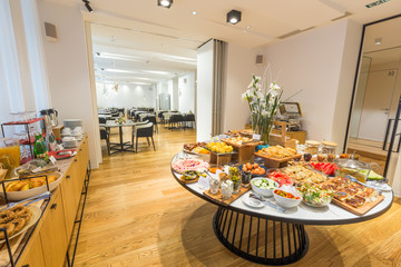 Breakfast served on round buffet table in hotel restaurant