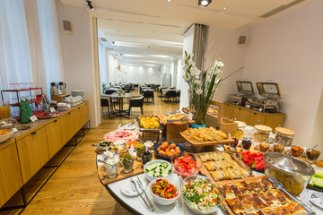 Breakfast served on round buffet table in hotel restaurant